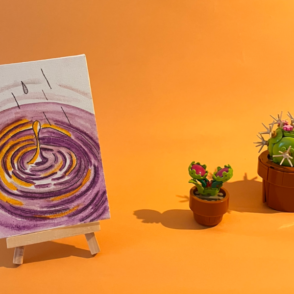 Photographie de l'oeuvre unique originale : une goutte qui tombe et crée des ondulations dans l'eau violette