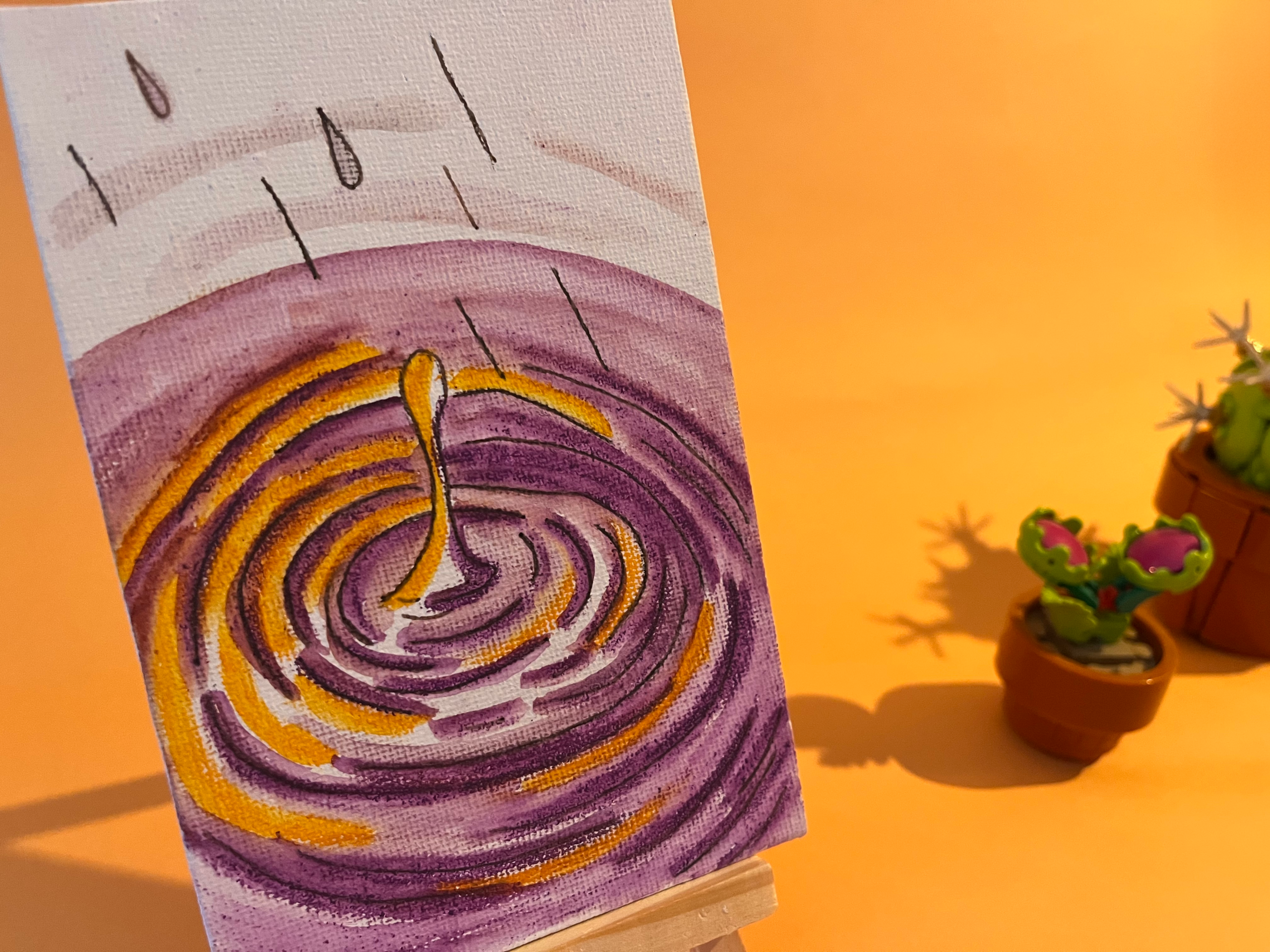 Photographie de l'oeuvre unique originale : une goutte qui tombe et crée des ondulations dans l'eau violette