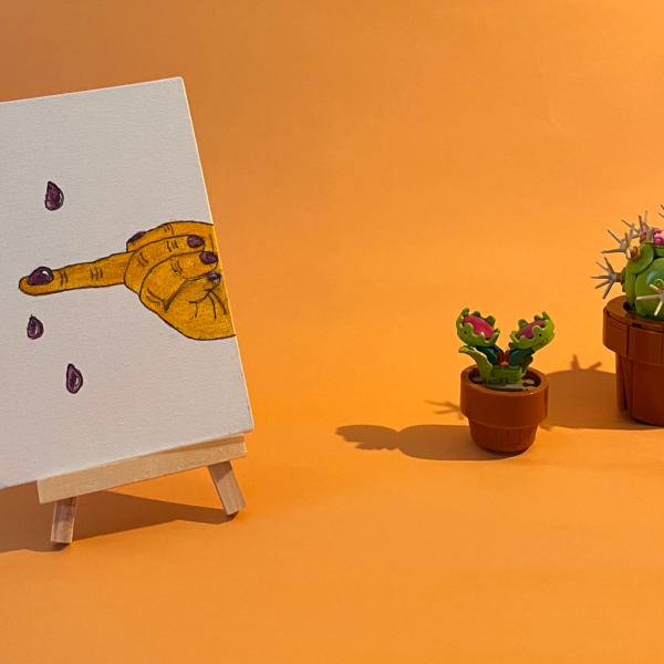 Photographie de l'oeuvre unique originale : une main attrape au vol les larmes qui tombent au sol