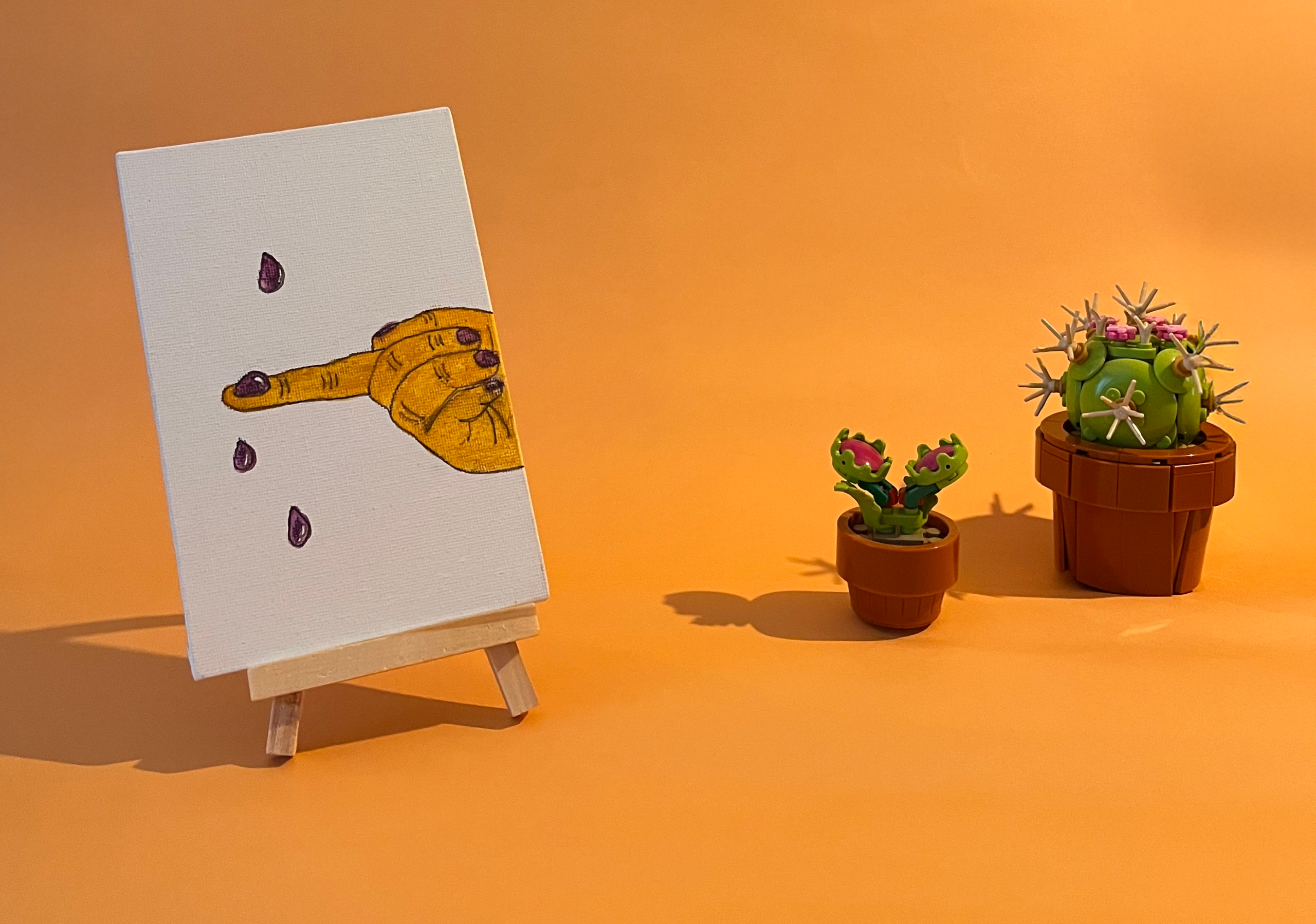 Photographie de l'oeuvre unique originale : une main attrape au vol les larmes qui tombent au sol